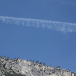mountain with jet trail in sky
