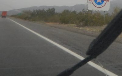 Rain falling on windshield as car enters Arizona
